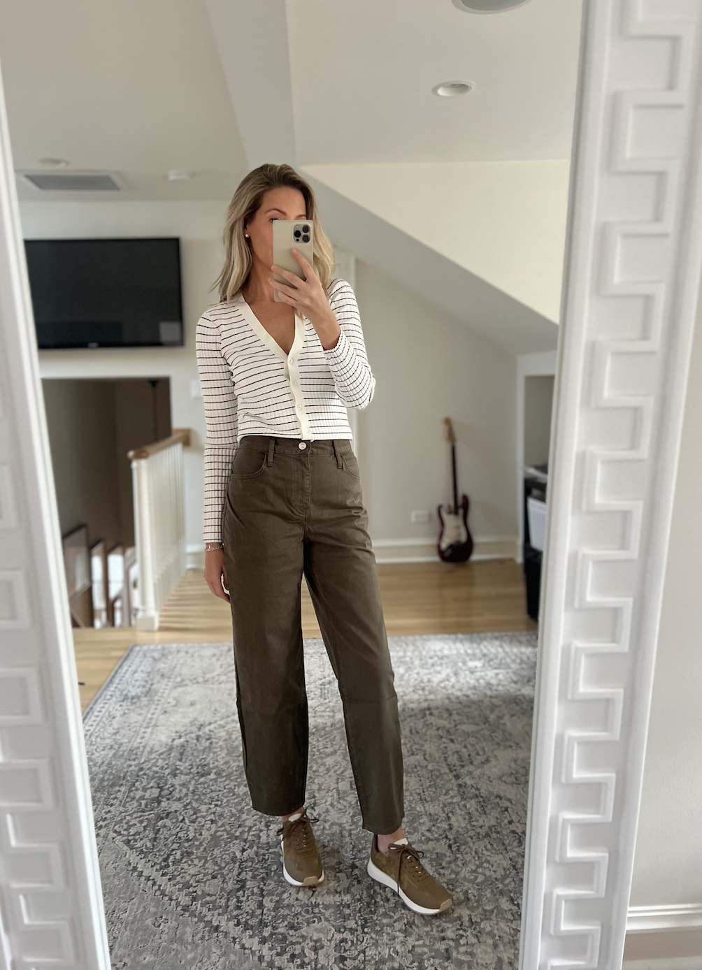 Woman wearing striped long sleeve with olive pants and sneakers